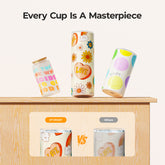 Colorful cups with artistic designs on a wooden surface, with text 'Every Cup Is A Masterpiece'.